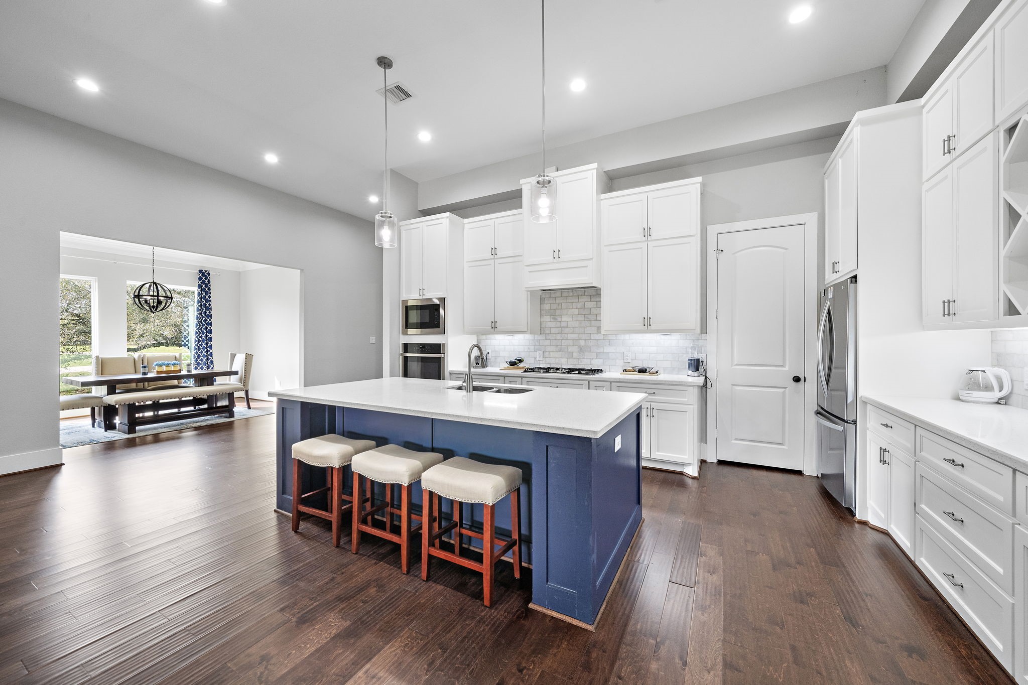 127 Cavalry Trail Drive Rosharon, TX 77583 - Photo 7 of 37 a kitchen with stainless steel appliances granite countertop a stove a sink dishwasher and a refrigerator with wooden floor