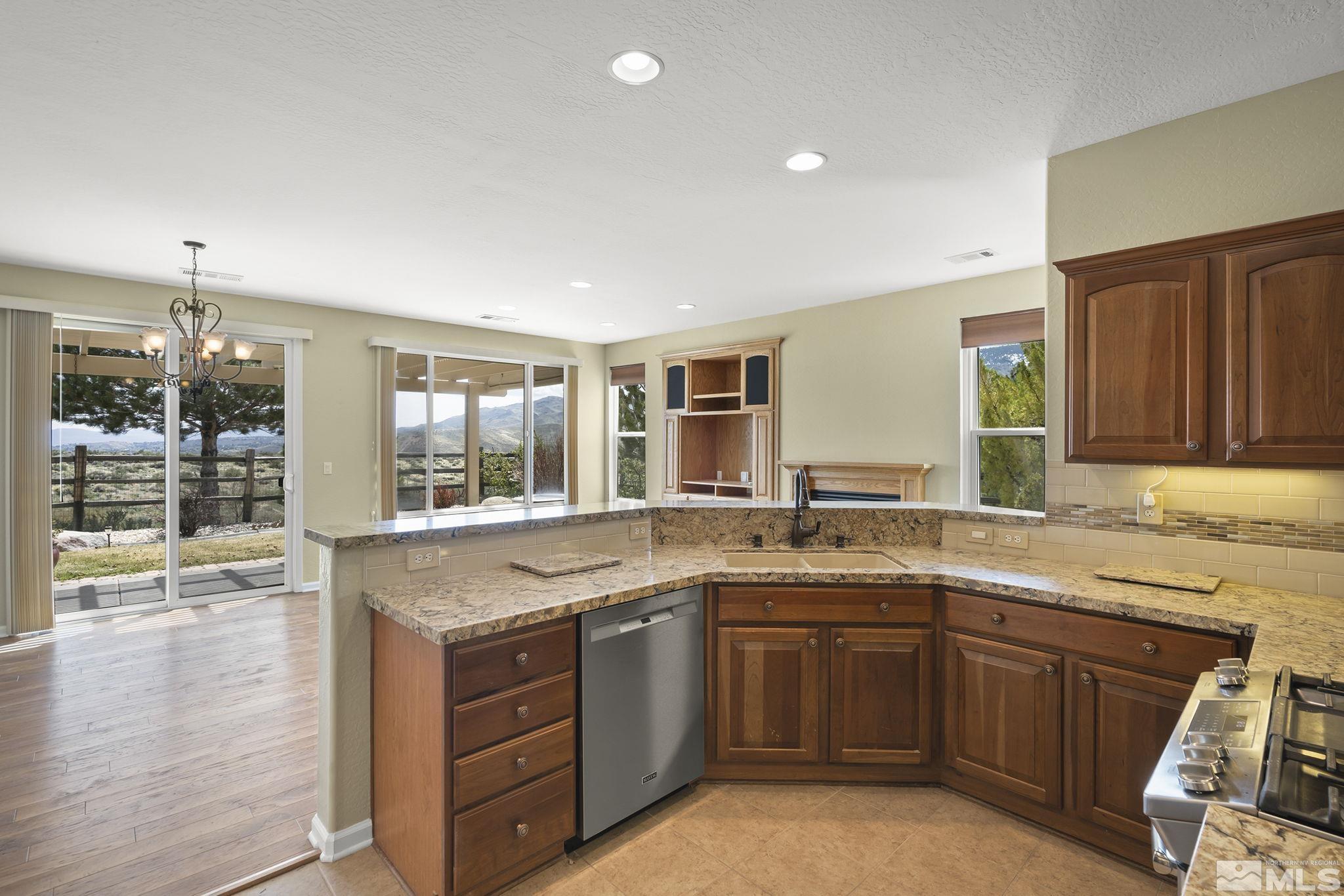 1210 Firefly Court Reno, NV 89523 - Photo 16 of 40 a kitchen with a sink stove and cabinets
