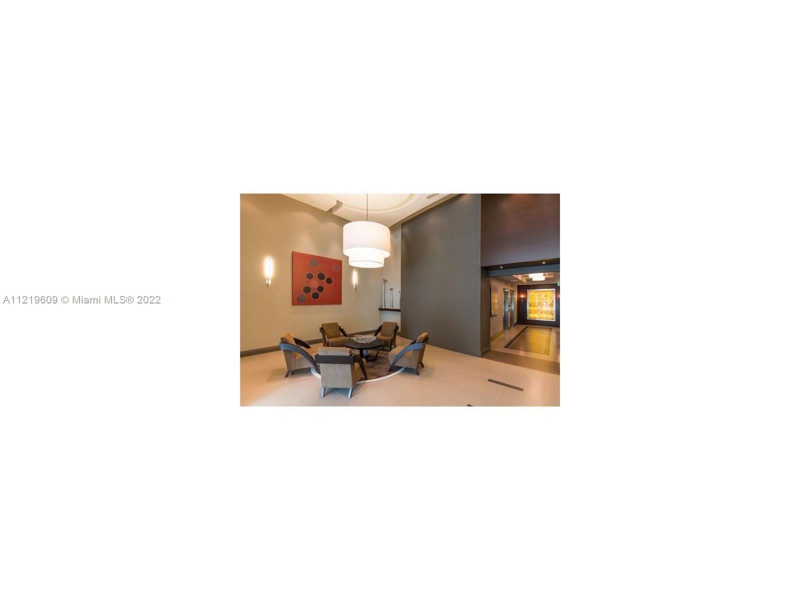 2525 Southwest 3rd Avenue, Unit 704 Miami, FL 33129 - Photo 2 of 13 a living room with furniture and a flat screen tv