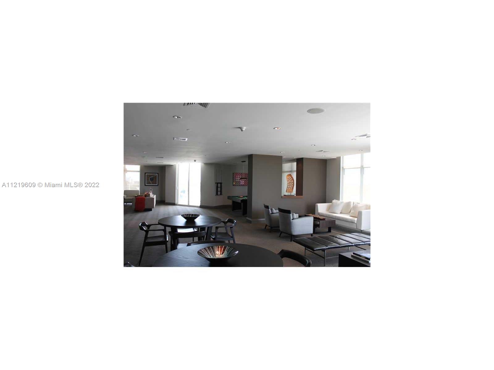 2525 Southwest 3rd Avenue, Unit 704 Miami, FL 33129 - Photo 7 of 13 a living room with furniture and a potted plant