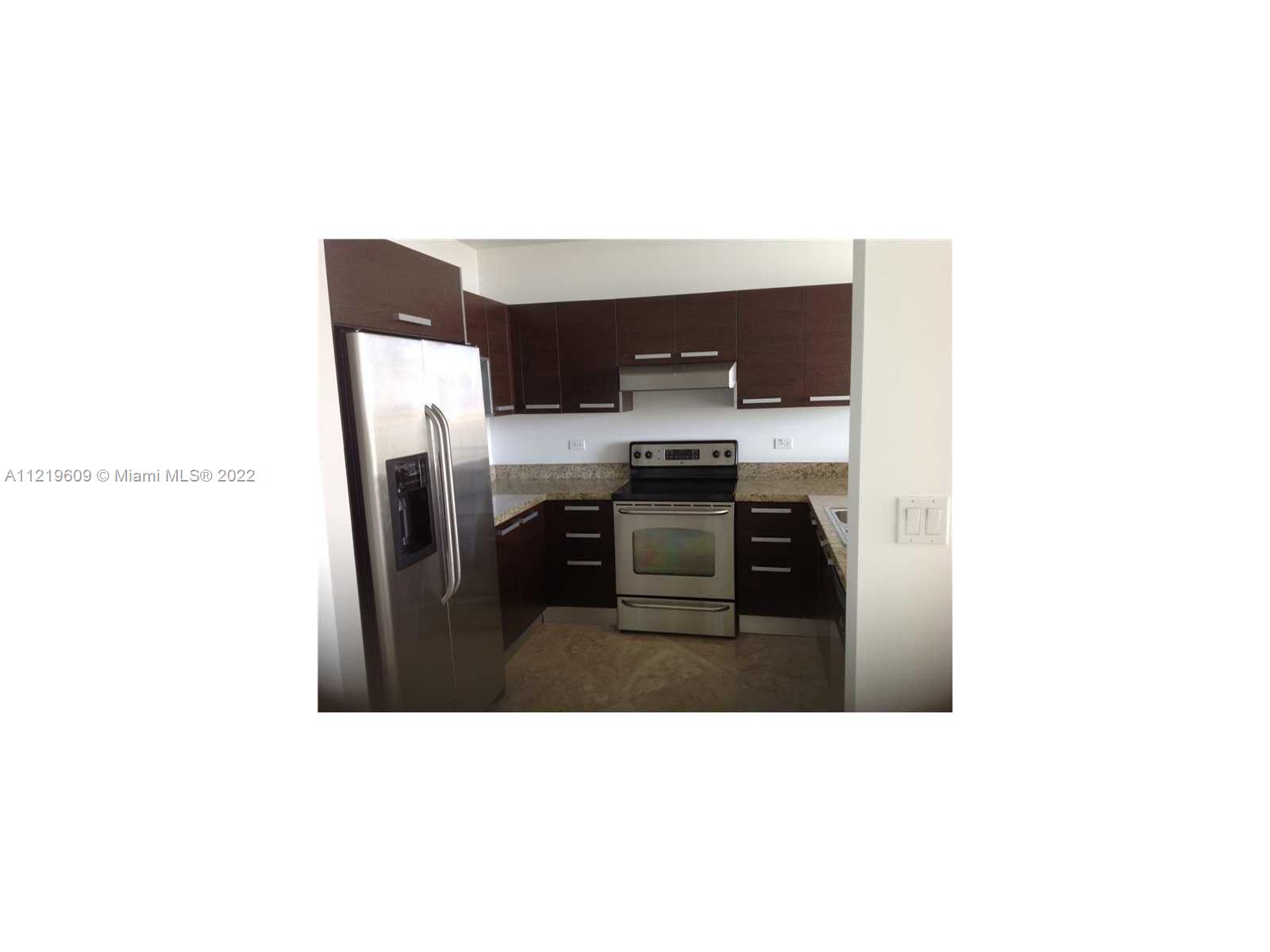 2525 Southwest 3rd Avenue, Unit 704 Miami, FL 33129 - Photo 8 of 13 a kitchen with a sink cabinets and stainless steel appliances