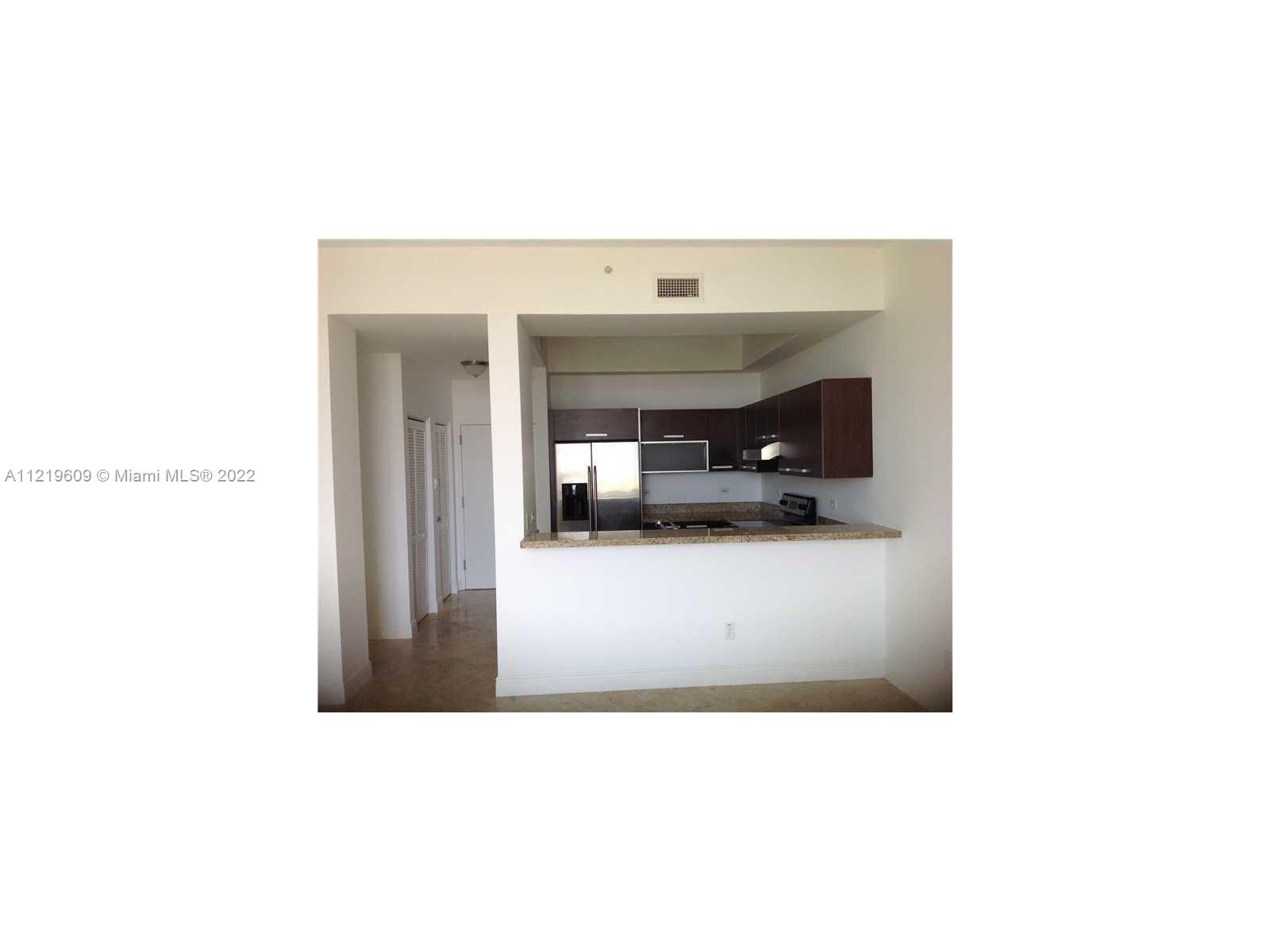 2525 Southwest 3rd Avenue, Unit 704 Miami, FL 33129 - Photo 9 of 13 a living room with a couch and a potted plant