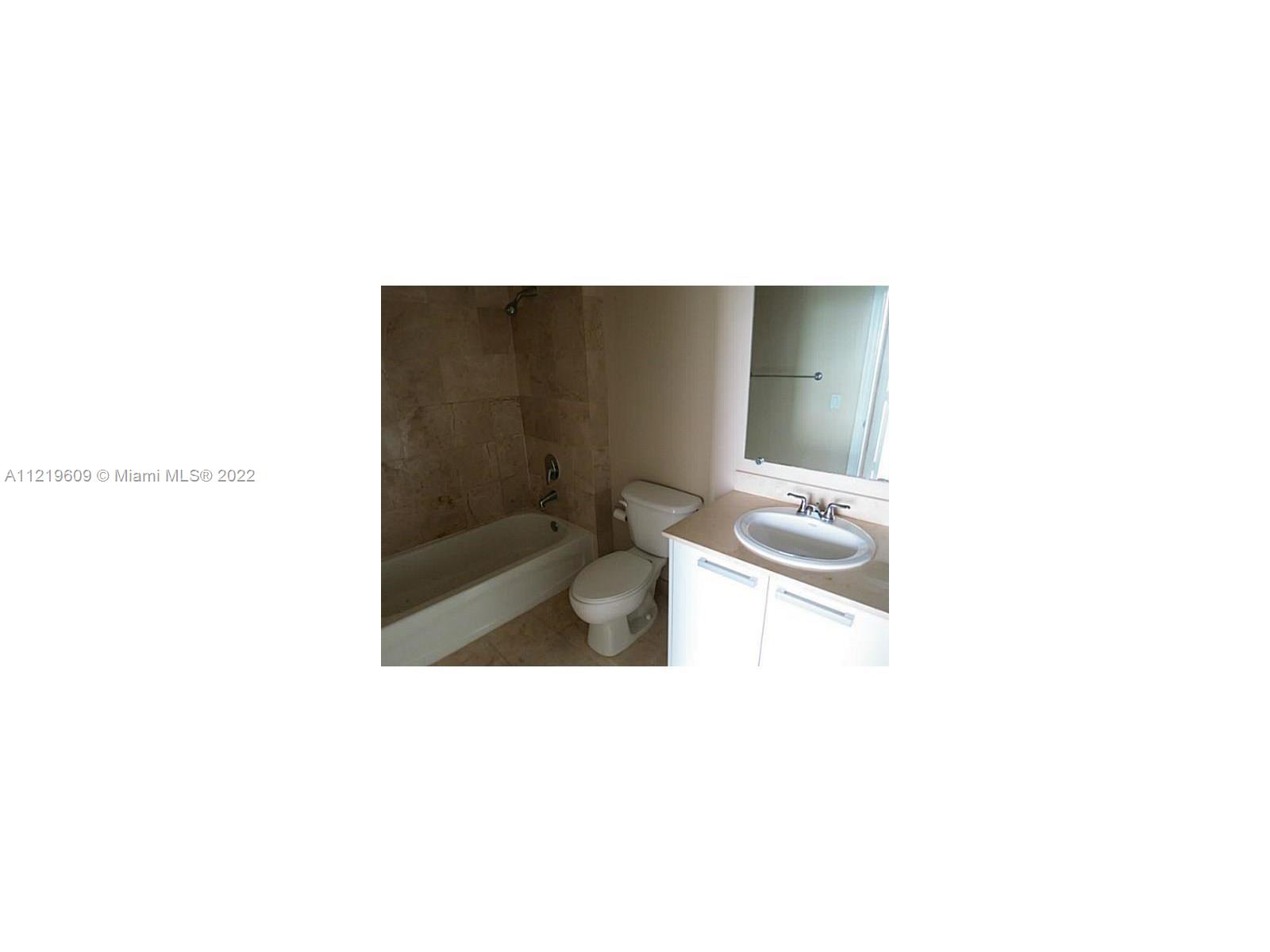 2525 Southwest 3rd Avenue, Unit 704 Miami, FL 33129 - Photo 10 of 13 a bathroom with a sink and a mirror
