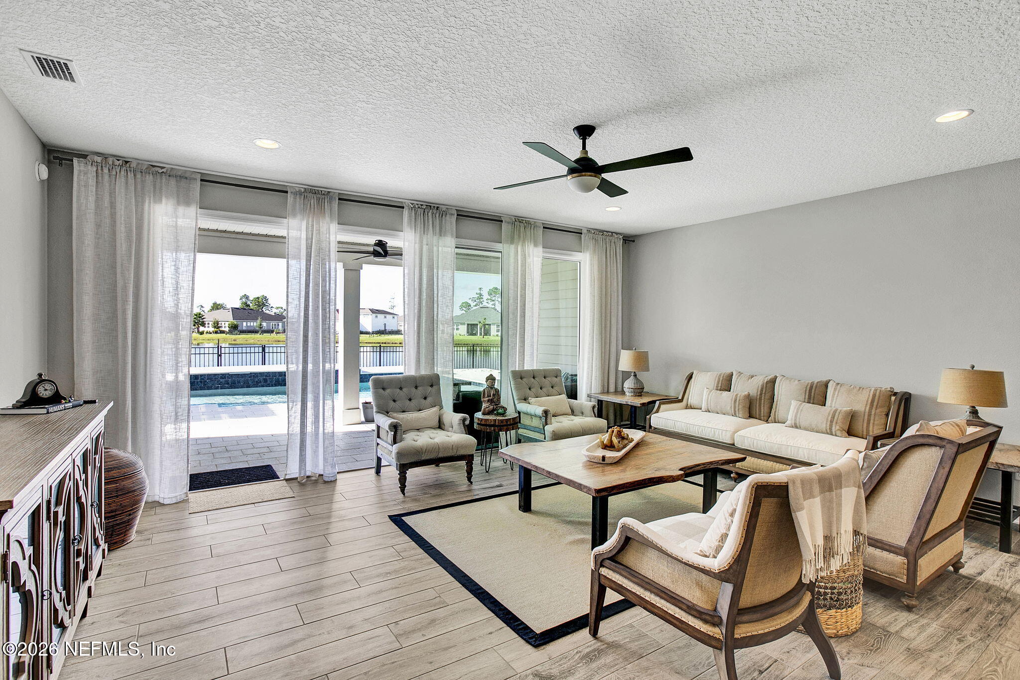 85401 Fall River Parkway Fernandina Beach, FL 32034 - Photo 11 of 38 a living room with furniture and a large window