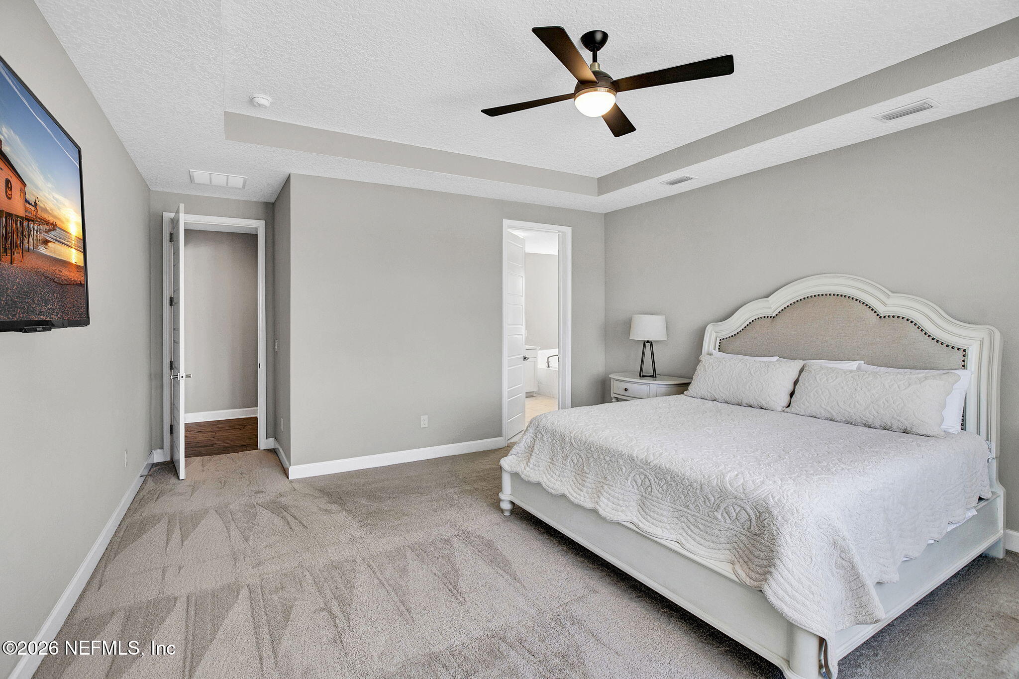 85401 Fall River Parkway Fernandina Beach, FL 32034 - Photo 14 of 38 a bedroom with a bed and a flat screen tv