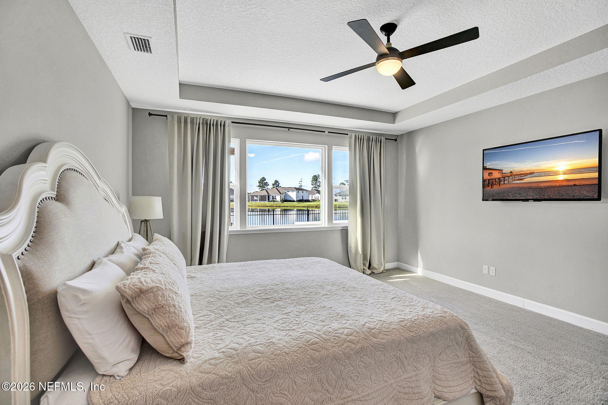 85401 Fall River Parkway Fernandina Beach, FL 32034 - Photo 15 of 38 a bedroom with a bed and a flat screen tv