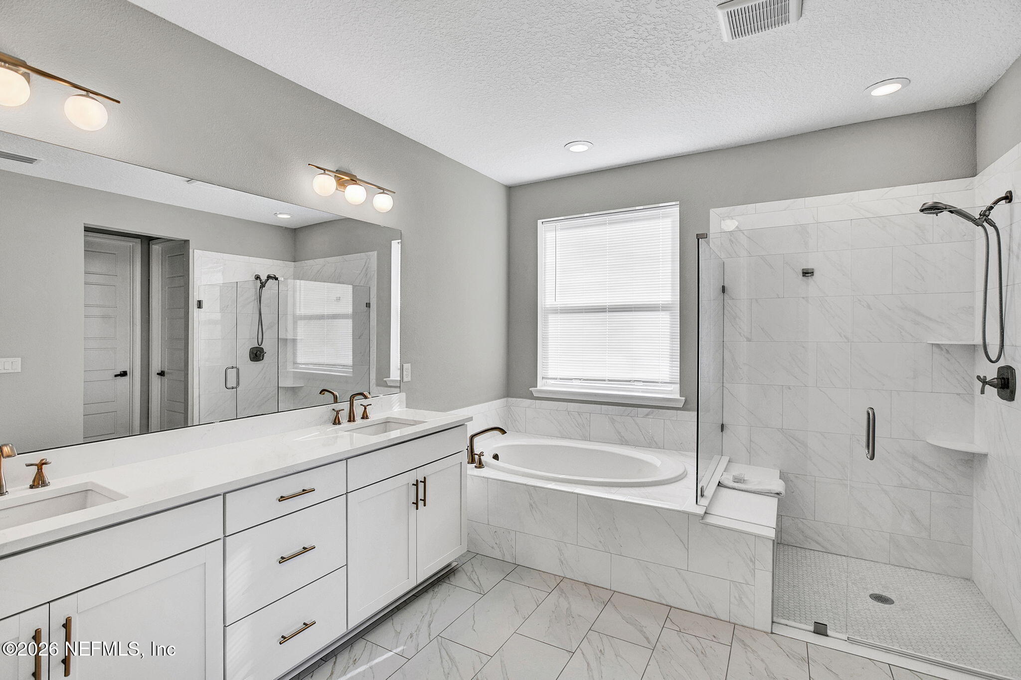 85401 Fall River Parkway Fernandina Beach, FL 32034 - Photo 16 of 38 a spacious bathroom with a tub sink shower and mirror
