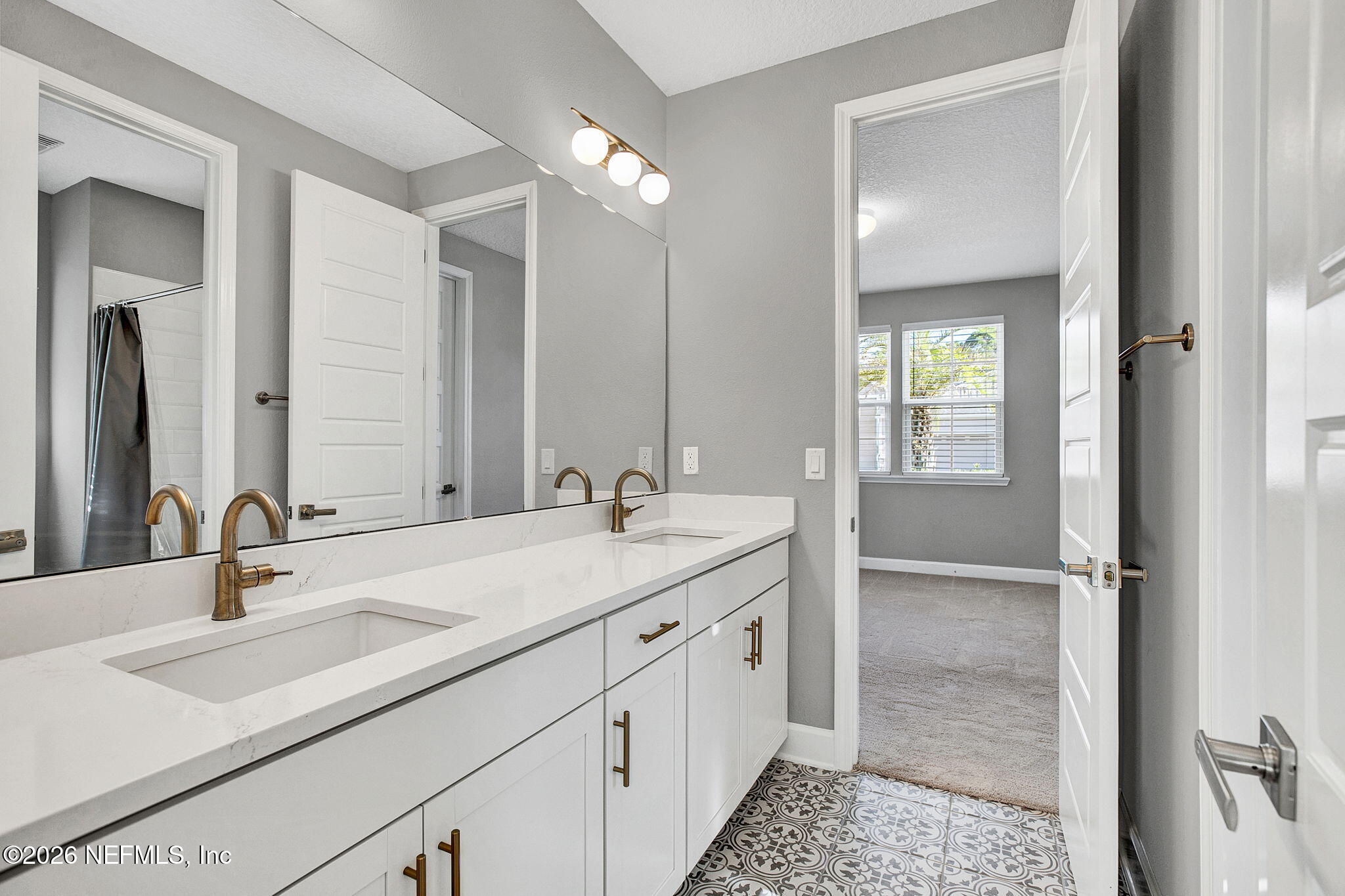 85401 Fall River Parkway Fernandina Beach, FL 32034 - Photo 18 of 38 a bathroom with double vanity sinks and a mirror