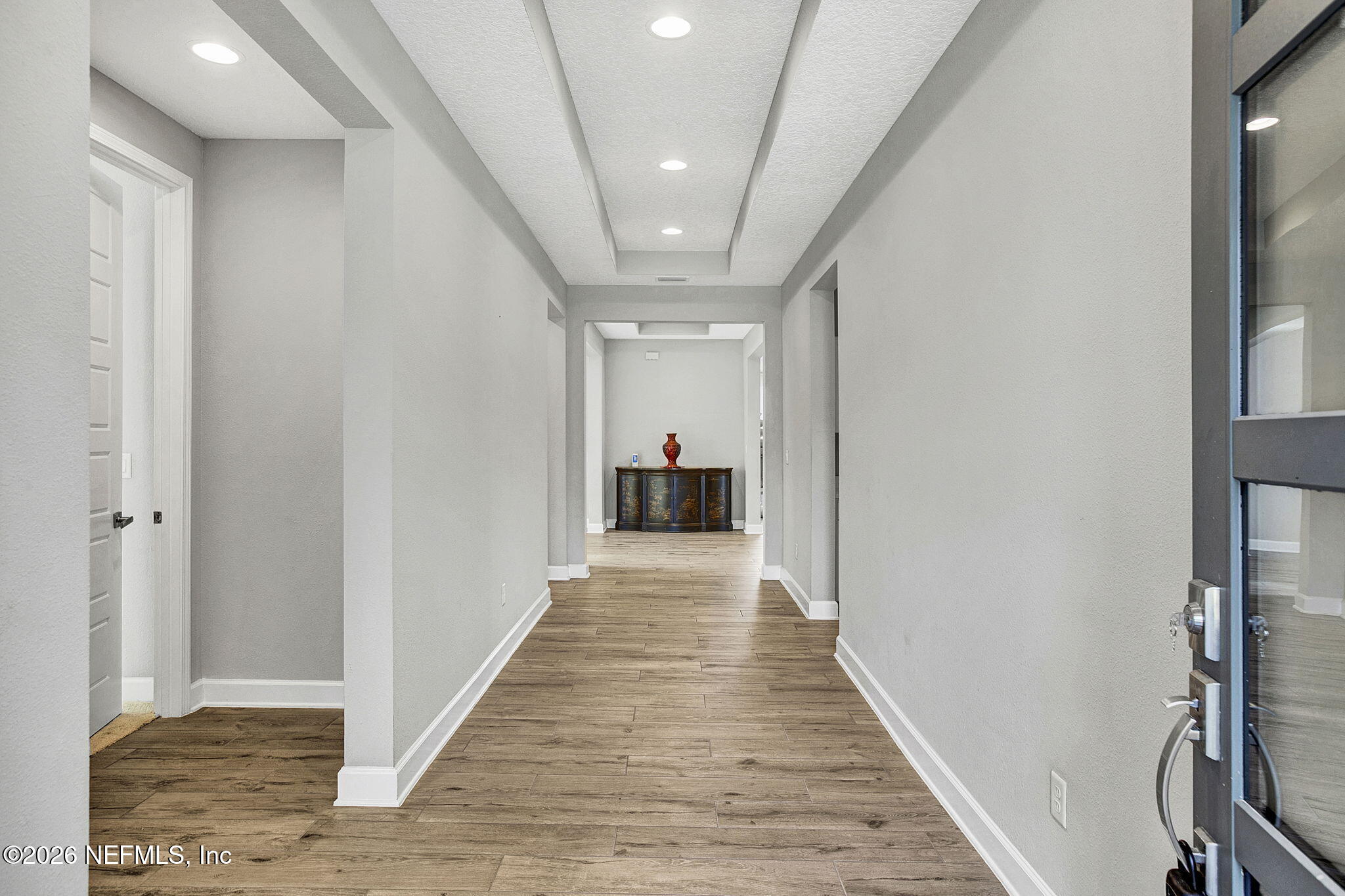 85401 Fall River Parkway Fernandina Beach, FL 32034 - Photo 27 of 38 a view of a hallway with wooden floor and staircase