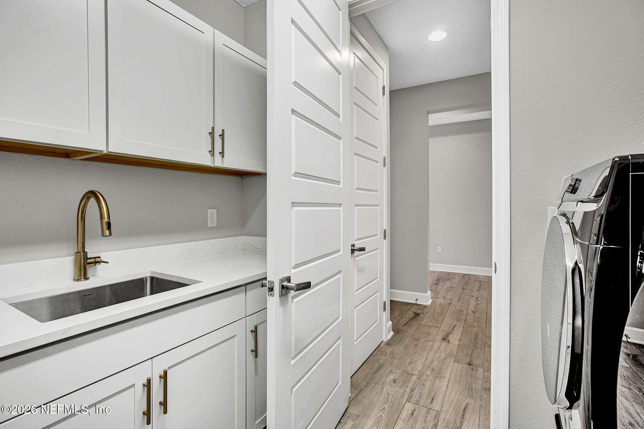 85401 Fall River Parkway Fernandina Beach, FL 32034 - Photo 31 of 38 a kitchen with a refrigerator and cabinets