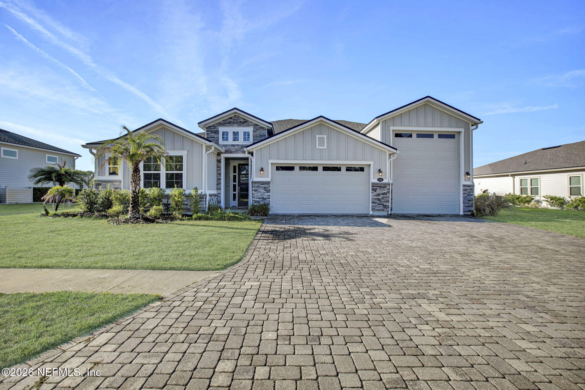 85401 Fall River Parkway Fernandina Beach, FL 32034 - Photo 35 of 38 a front view of a house with a yard and garage