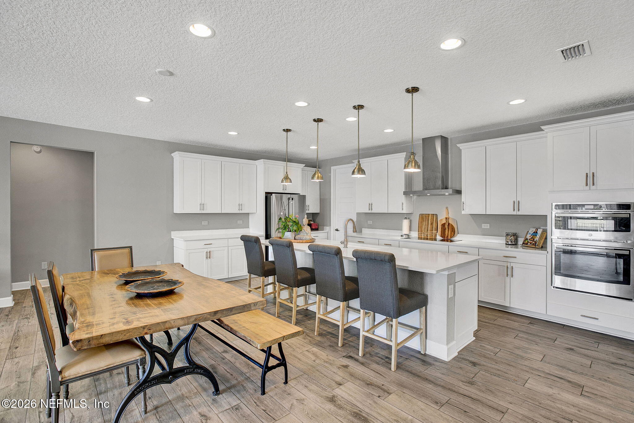 85401 Fall River Parkway Fernandina Beach, FL 32034 - Photo 7 of 38 a kitchen with a dining table chairs stove refrigerator and cabinets