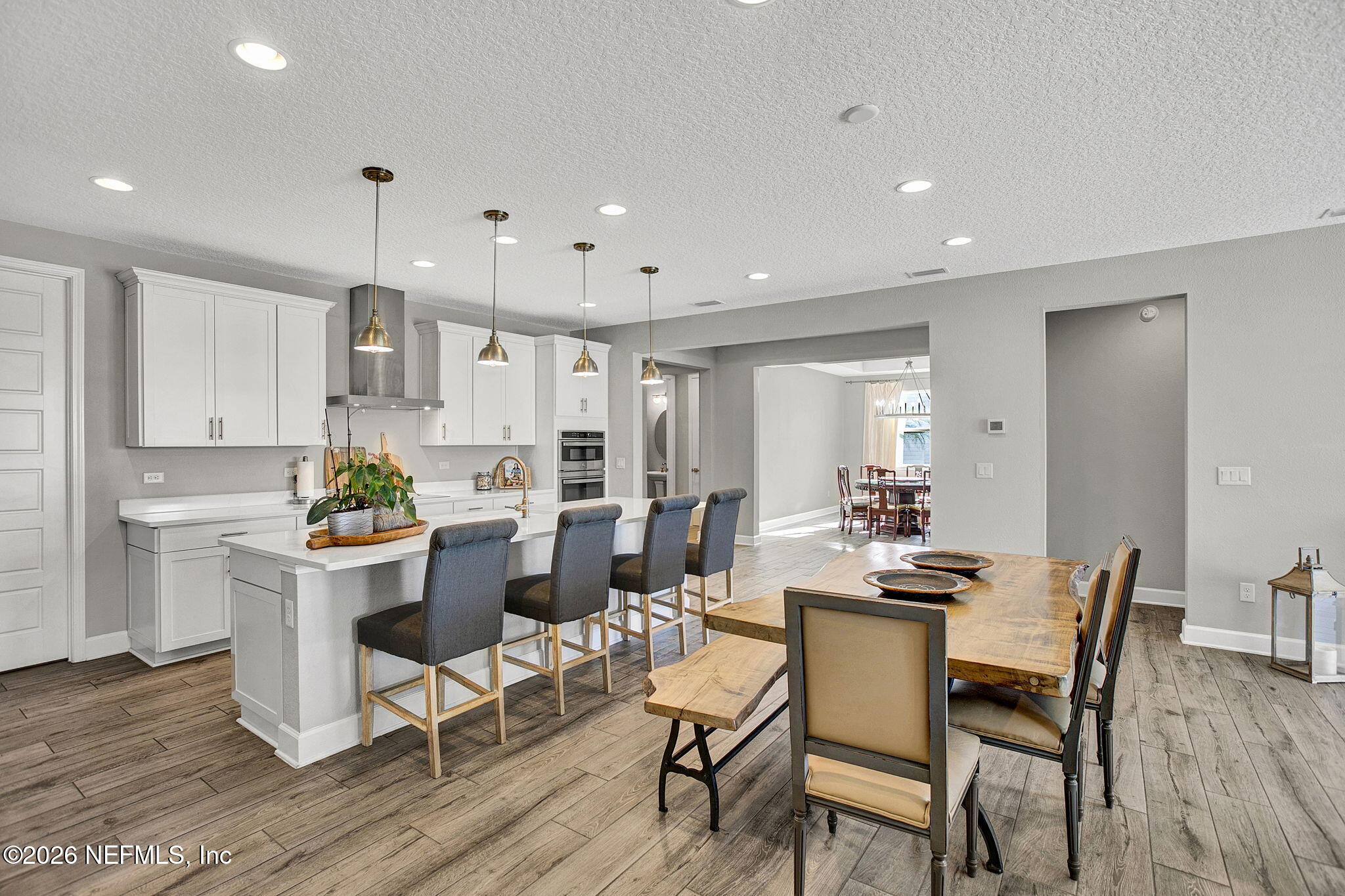 85401 Fall River Parkway Fernandina Beach, FL 32034 - Photo 9 of 38 a kitchen with a dining table chairs and wooden floor