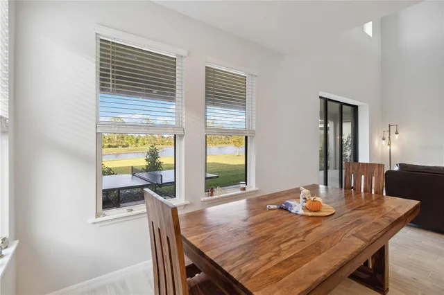 a living room with furniture kitchen view and a refrigerator