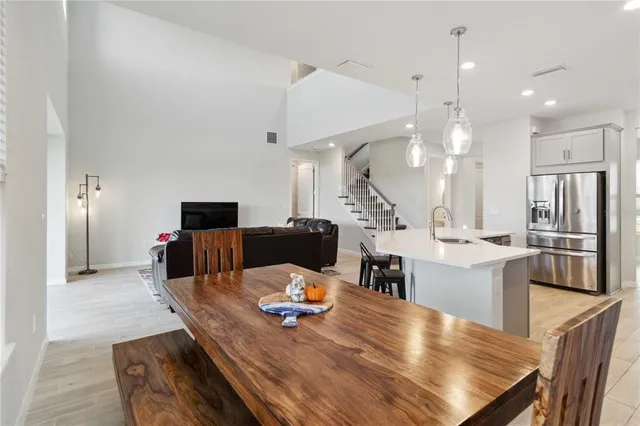 a kitchen with kitchen island a dining table and chairs