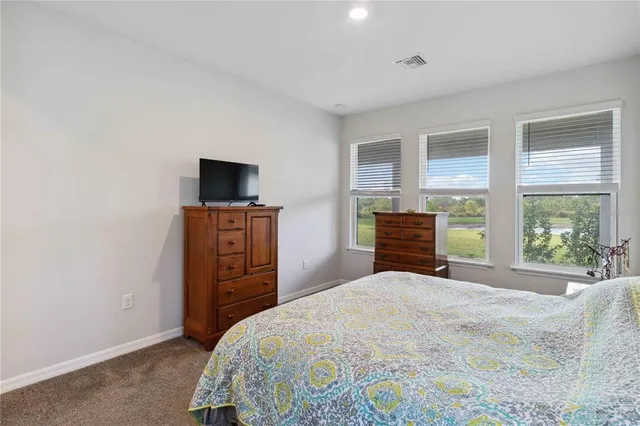 a bedroom with a bed and a mirror