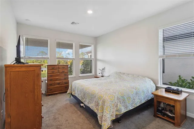a bathroom with a tub a sink and mirror