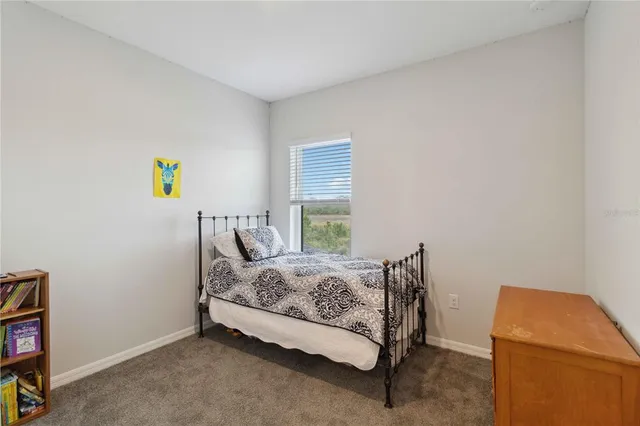a bedroom with a bed and flat screen tv