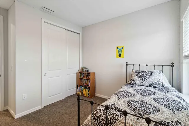 a bedroom with bed and a window