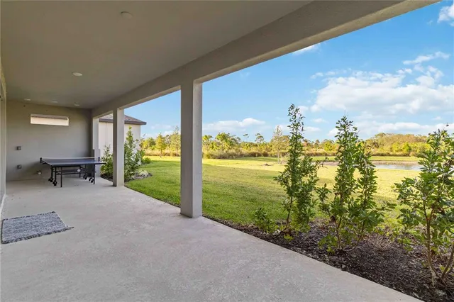 an aerial view of a house with a garden and lake view