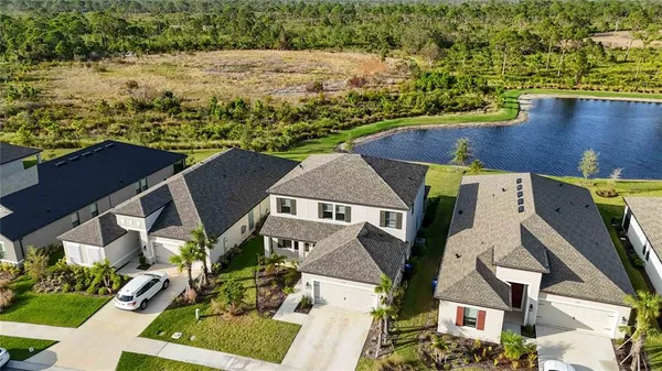 an aerial view of a house with swimming pool and ocean view