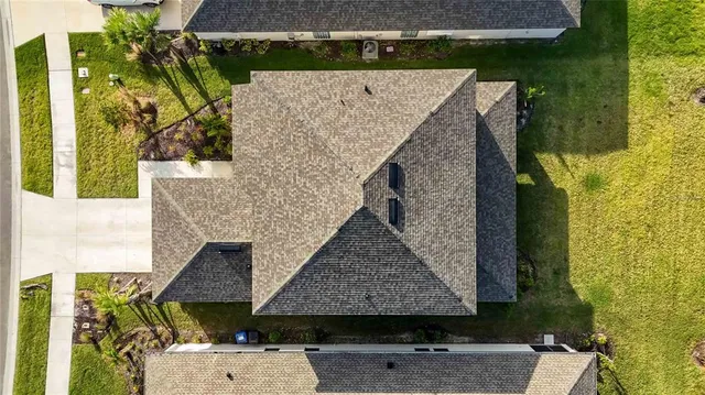 an aerial view of a house with swimming pool and outdoor space