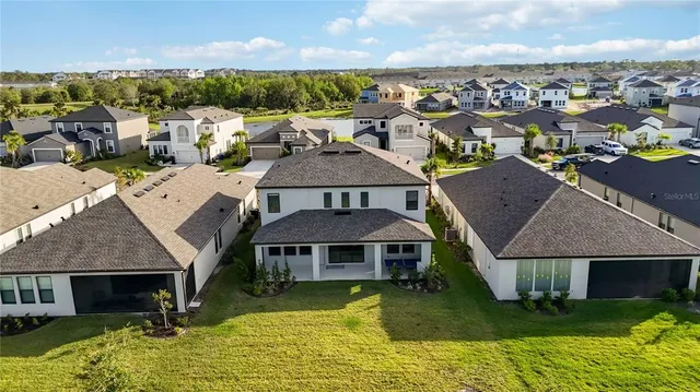 an aerial view of a house with a swimming pool