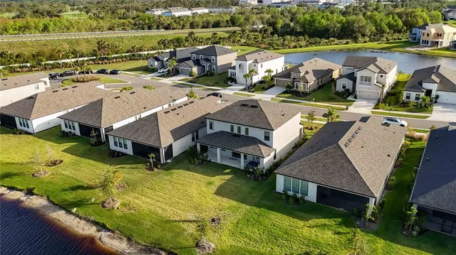 an aerial view of residential house with outdoor space and parking