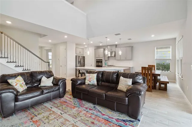 a kitchen with stainless steel appliances kitchen island granite countertop a sink and a refrigerator