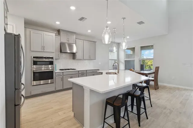 a large kitchen with cabinets a sink and appliances