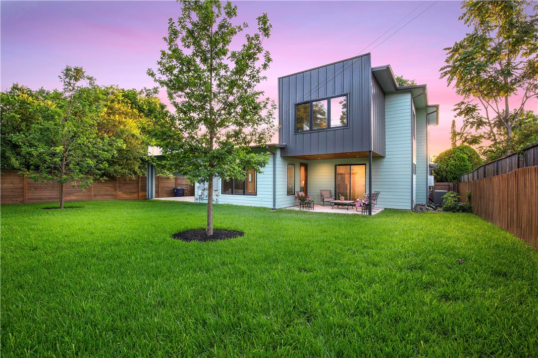 a house with green field in front of it