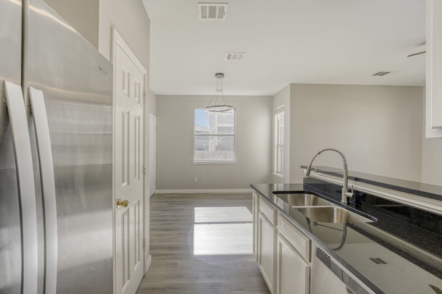 904 Sebastian Bend, Unit B Pflugerville, TX 78660 - Photo 8 of 30 a kitchen with stainless steel appliances granite countertop a sink and a refrigerator