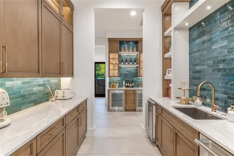 a kitchen with a sink and a stove top oven