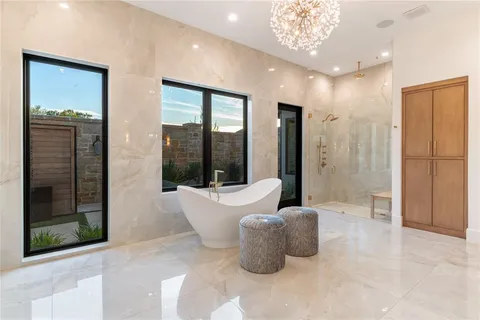 a bathroom with a bathtub and shower