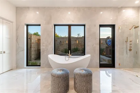 a bathroom with a tub mirror and window