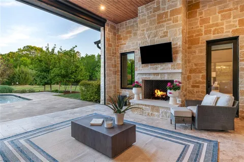 a living room with fireplace furniture and a flat screen tv