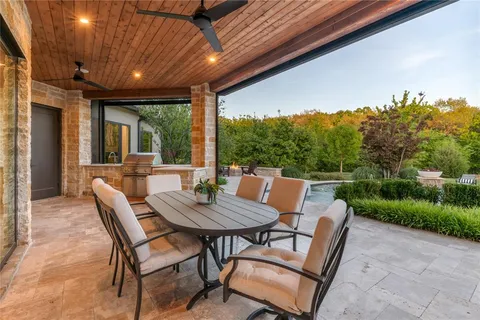a view of yard from deck with patio