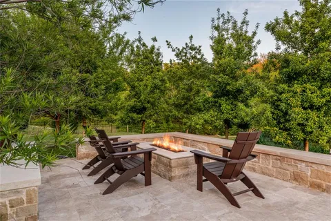 a view of a backyard with chairs