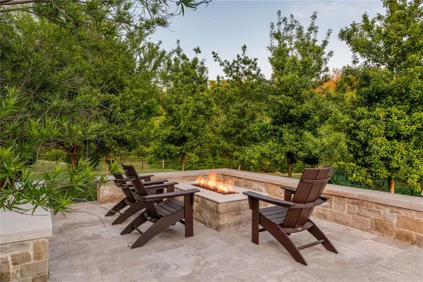 a view of a backyard with chairs