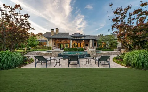 a swimming pool with outdoor seating and yard