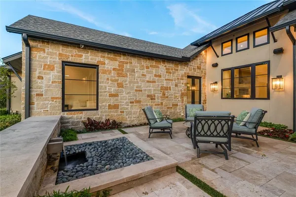 a front view of a house with outdoor seating