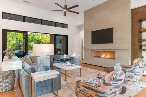 a living room with furniture a fireplace and a flat screen tv