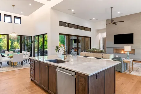 a view of kitchen island a sink and living room