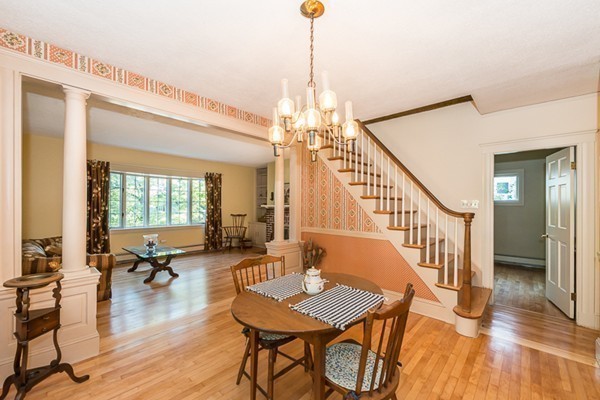 39 Farmcrest Avenue Lexington, MA 02421 - Photo 3 of 26 a dining room with wooden floor a chandelier a wooden table and chairs