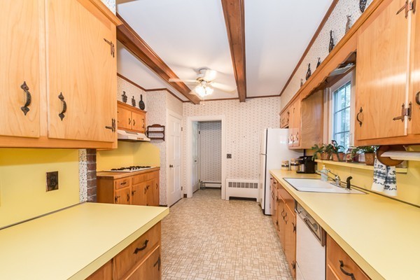 39 Farmcrest Avenue Lexington, MA 02421 - Photo 9 of 26 a large kitchen with a stove a sink dishwasher and a refrigerator with wooden floor
