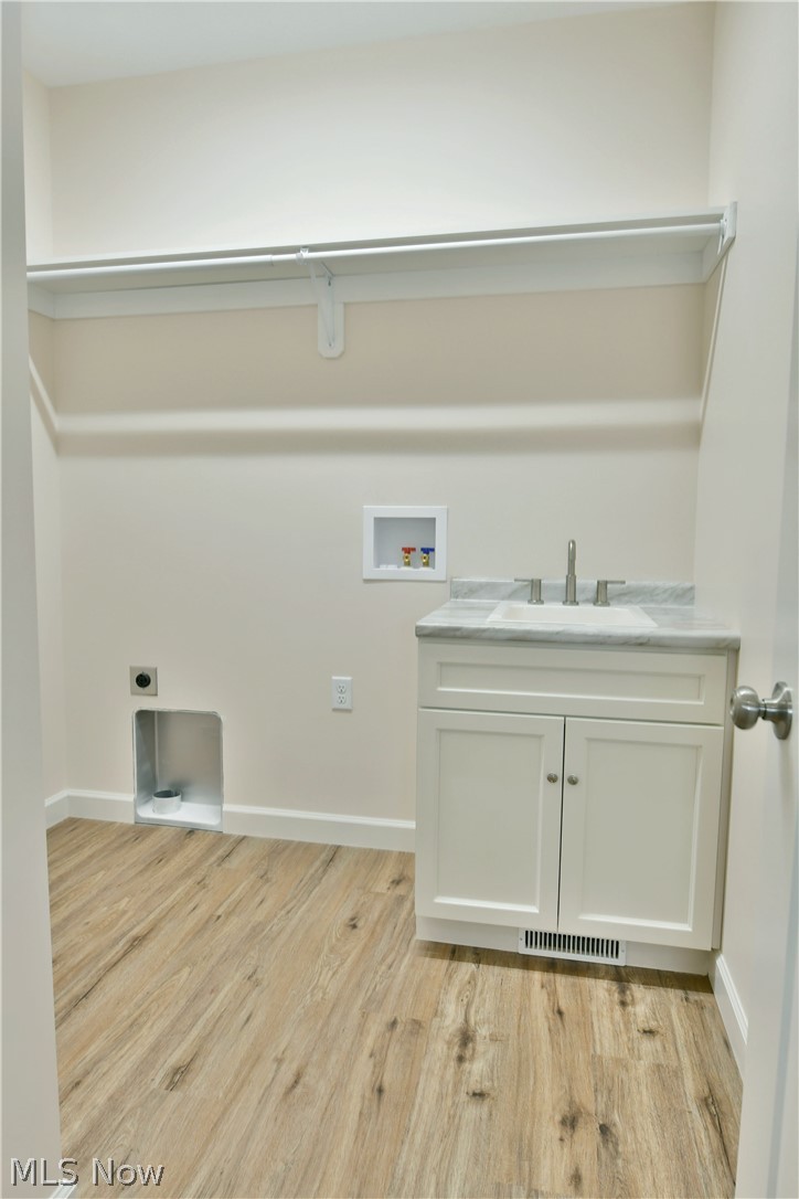 6834 Palmyra Road Southwest Warren, OH 44481 - Photo 14 of 33 Washroom with electric dryer hookup, sink, and light hardwood / wood-style flooring
