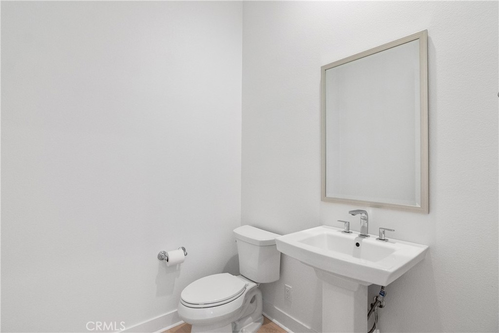 11734 Hillsborough Lane Porter Ranch, CA 91326 - Photo 19 of 34 a bathroom with a toilet a sink and mirror