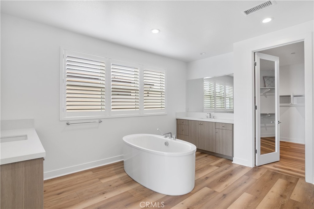 11734 Hillsborough Lane Porter Ranch, CA 91326 - Photo 23 of 34 a white room with wooden floor and windows