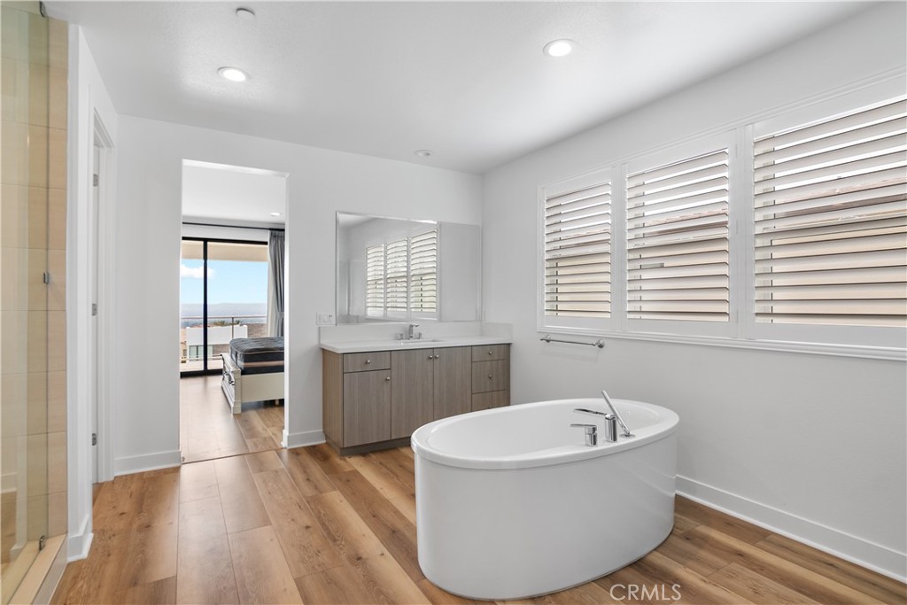 11734 Hillsborough Lane Porter Ranch, CA 91326 - Photo 24 of 34 a bathroom with a bathtub and windows