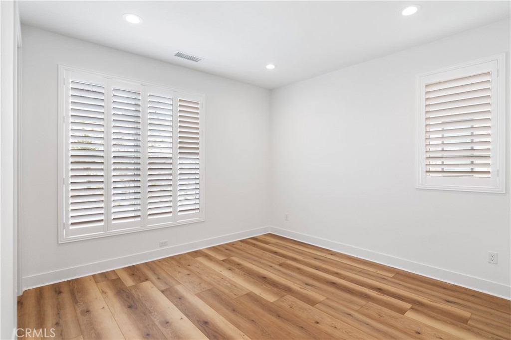 11734 Hillsborough Lane Porter Ranch, CA 91326 - Photo 31 of 34 a view of an empty room with wooden floor and a window